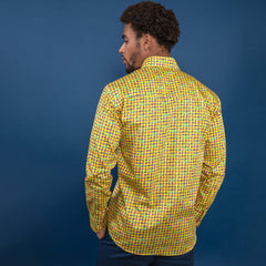 Man wearing vibrant multicolour houndstooth printed shirt from Claudio Lugli, showcasing the back view against a blue background.