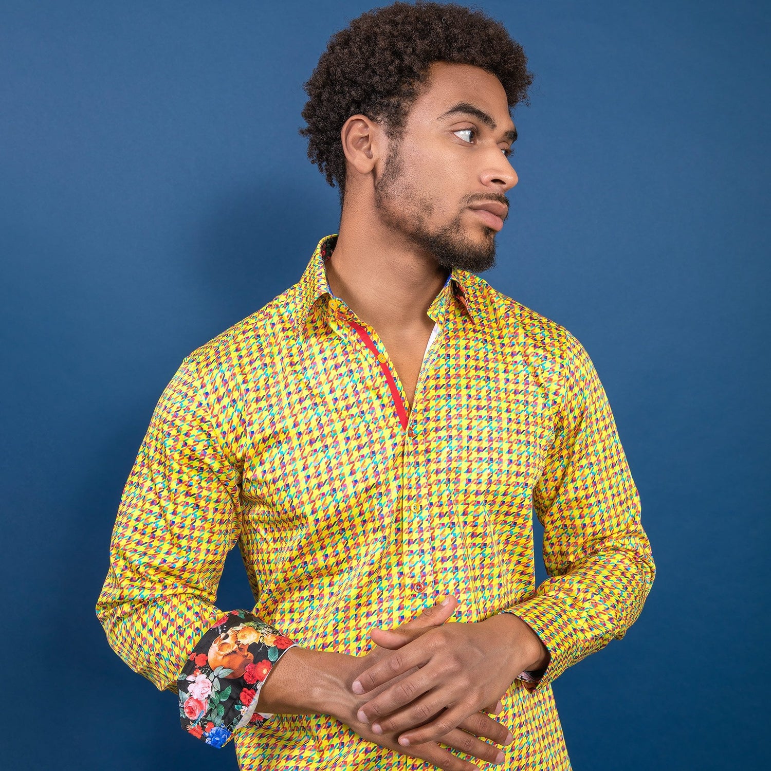 Man wearing Claudio Lugli Houndstooth Multicolour Printed Shirt in vibrant kaleidoscope colors against a blue background