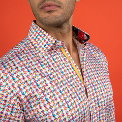 Close-up of man wearing Claudio Lugli Houndstooth Multicolour Printed Shirt with vibrant pattern against an orange background.