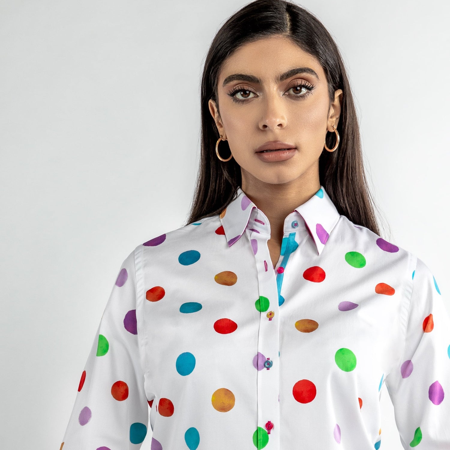 Woman wearing multicolour polkadot print shirt with vibrant polka dots, perfect for a quirky office look or laid-back weekend vibe.