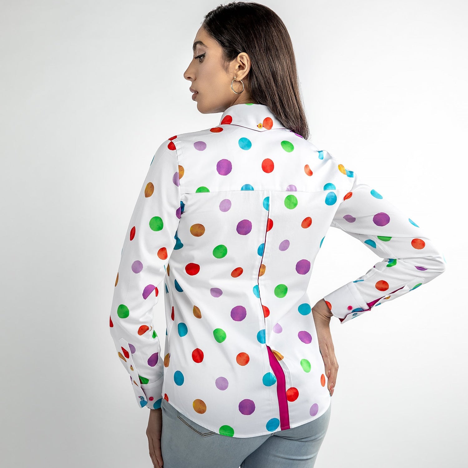 Woman wearing a multicolour polkadot shirt, back view, showcasing vibrant dots against a satin and cotton blend fabric