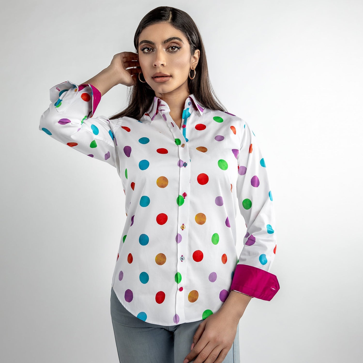 Woman wearing multicolour polkadot print shirt, vibrant polka dots on satin and cotton blend, stylish and playful fashion choice