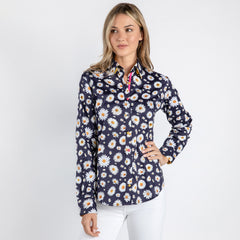 Woman wearing navy daisy flower print women's shirt paired with white pants, featuring a silky-smooth satin and cotton blend for comfort.