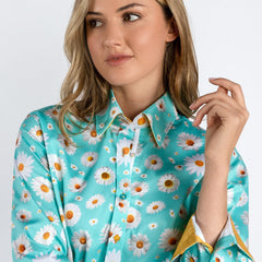 Woman wearing a Daisy Flower Print Women's Shirt in sky blue with yellow accents, featuring a luxurious satin and cotton blend.