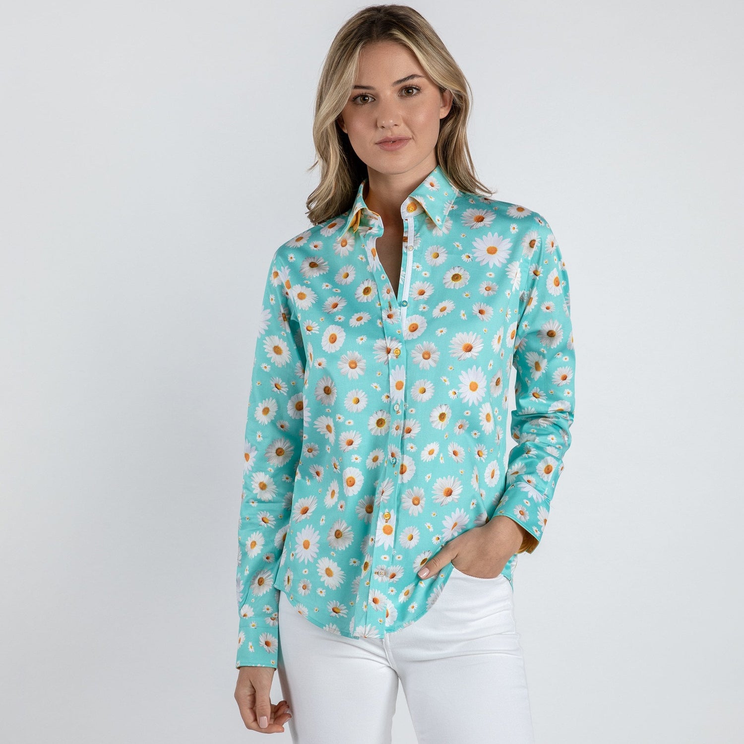 Woman wearing sky blue shirt with daisy print and white pants