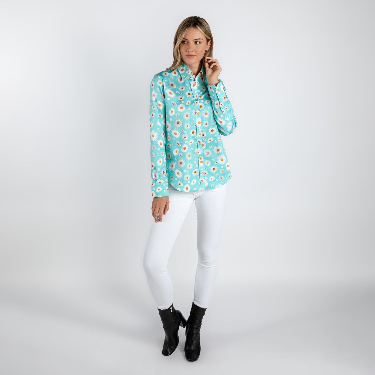 Woman wearing Daisy Flower Print Women's Shirt in sky blue with white pants and black boots