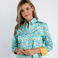 Woman wearing Daisy Flower Print Women's Shirt in sky color, featuring a delightful daisy pattern and luxurious satin-cotton blend.