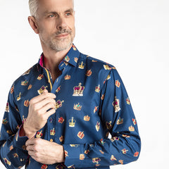 Man wearing "THE CROWN" Regal Print Shirt by Claudio Lugli, featuring colorful crown motifs, fuchsia inserts, and an aqua placket strip.