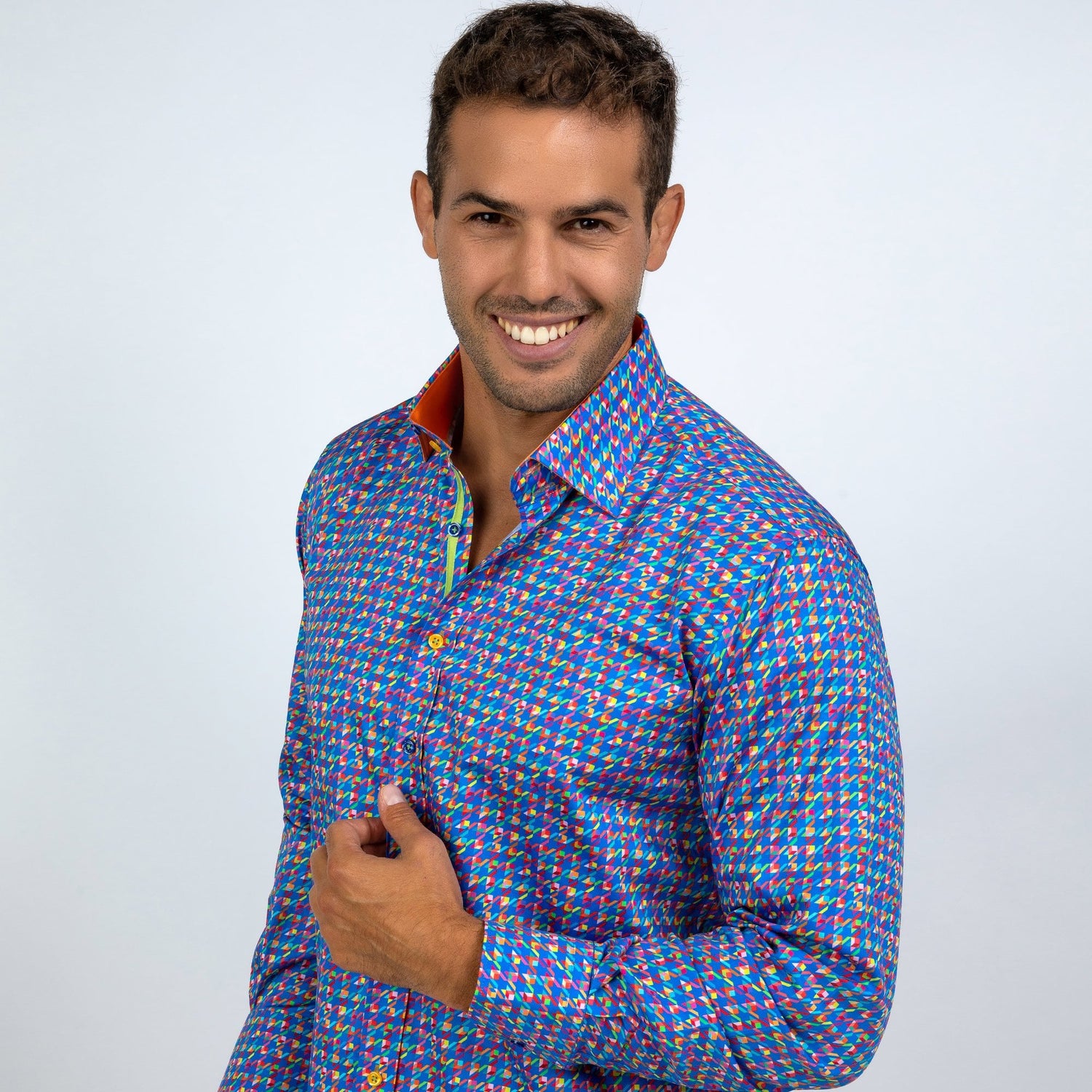 Man wearing a vibrant multicolour houndstooth printed shirt made from luxurious satin cotton by Claudio Lugli, showcasing style and sophistication.