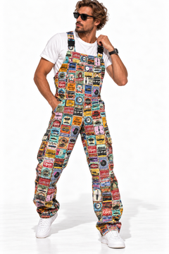 Claudio Lugli Retro Car Service Overalls on a model, front view showing a multicolour vintage motoring-sign collage, bib pocket and loose legs with white trainers