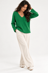 Claudio Lugli Soft Touch Jumper in emerald green, women's V-neck knit worn with white wide-leg trousers, front view